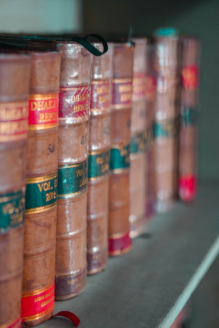 hero-img-02 Close-up of leather-bound law books arranged neatly on a bookshelf, showcasing traditional literature.